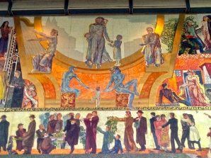 When City Hall opened, "The Nation at Work and Play" (officially entitled "Work, Administration, Celebration") was advertised as the world's largest oil painting, measuring more than 42 x 74 feet. Muralist Henrik Sørenson actually painted it on a series of wooden panels. These in the center depict Charity, surrounded by Culture, Philosophy, and Family.