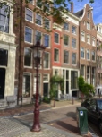 Pictured is the skinniest home in Amsterdam. (It's the narrow, bright red house.) Its entrance measures only about a yard wide, but it opens up towards the back. The saying goes that "Only the wealthy can live on the inside of a canal's curve," because their homes had to have wider fronts to accommodate the bend in the waterway.