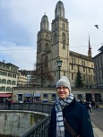 Matthew stands in front of Grossmünster's twin steeples, which have become the city symbol. The Neo-Gothic domes are replacements for the originals, which were damaged in a fire in 1781.