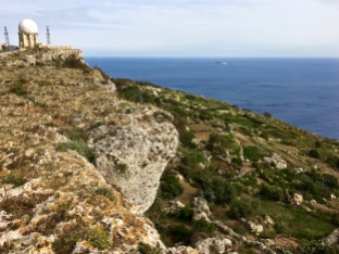 A shift along the Maghlaq Fault line has given an upward tilt to the Dingli Cliffs and created a rift between the layers of limestone. From the Upper Coralline Limestone ledge, you can look down on the Lower Coralline layer blanketed with farmers' fields. Tiny Fifla shimmers on the distant horizon.